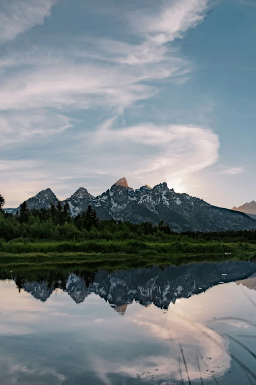 an outdoor area that has a lake, and mountains in the background