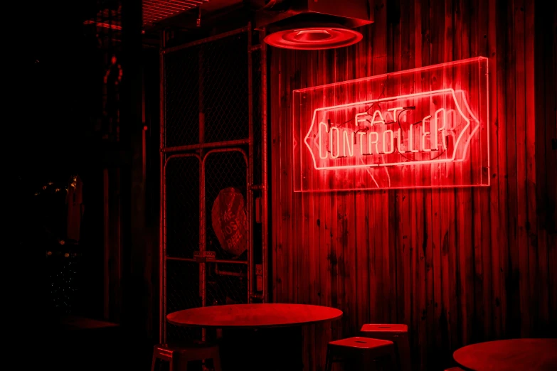 a bar with neon signs above a red light