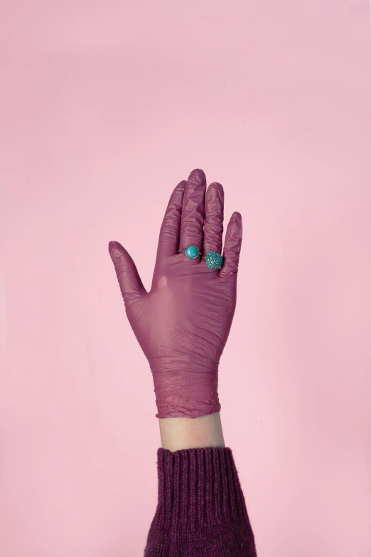 purple cotton gloves and green jade ring are featured in this image