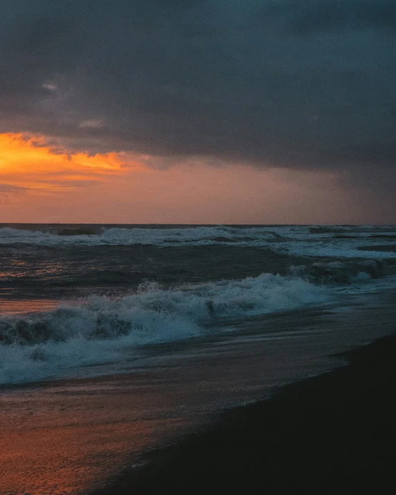 the beach has a few waves coming in