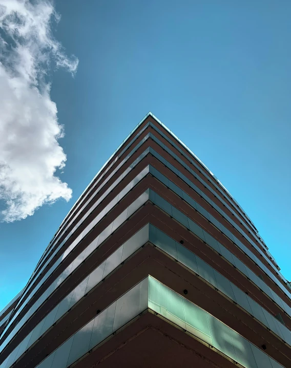 a very tall building that is under a cloudy sky