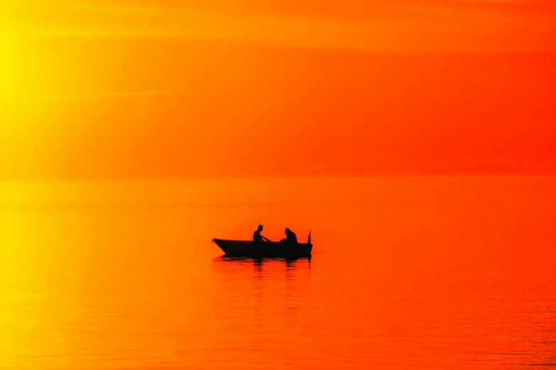 a couple of men are in a small boat