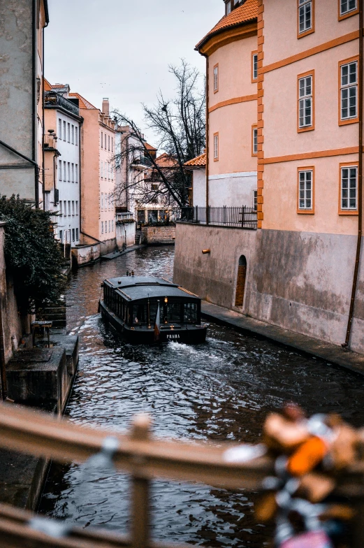 a boat in a river next to some buildings