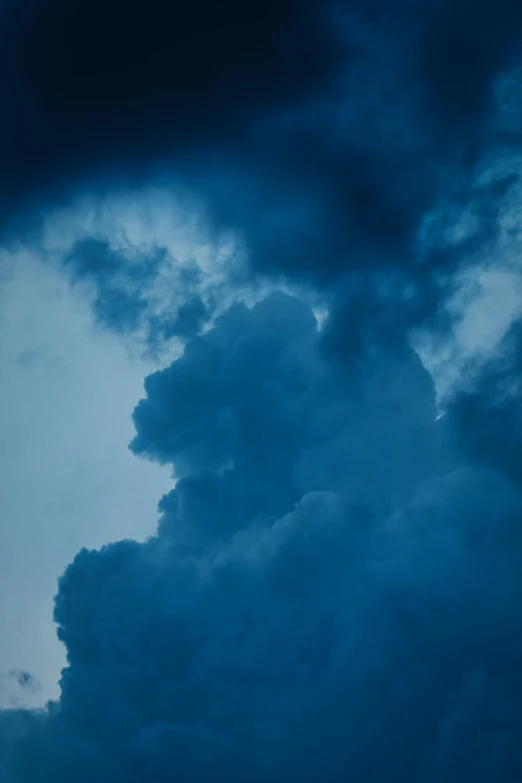 there is a plane in the sky with dark clouds