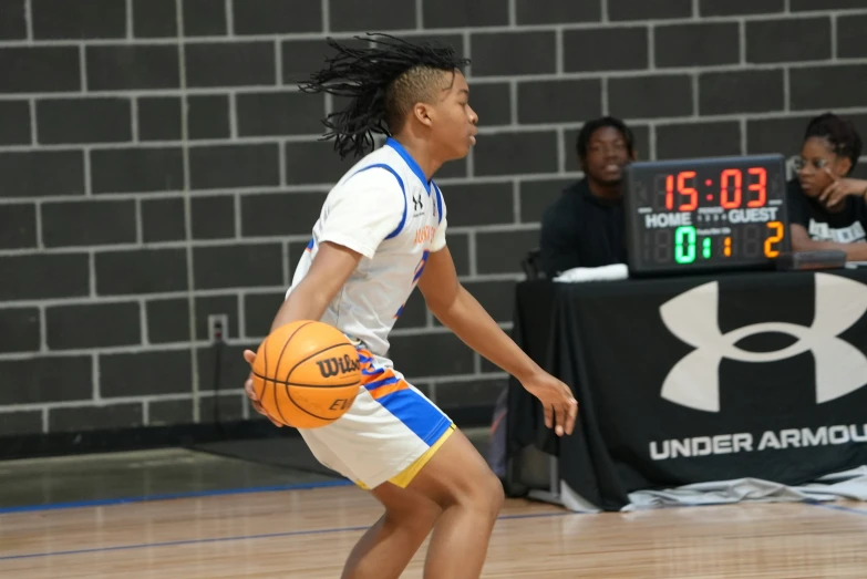 a women is playing basketball on a court