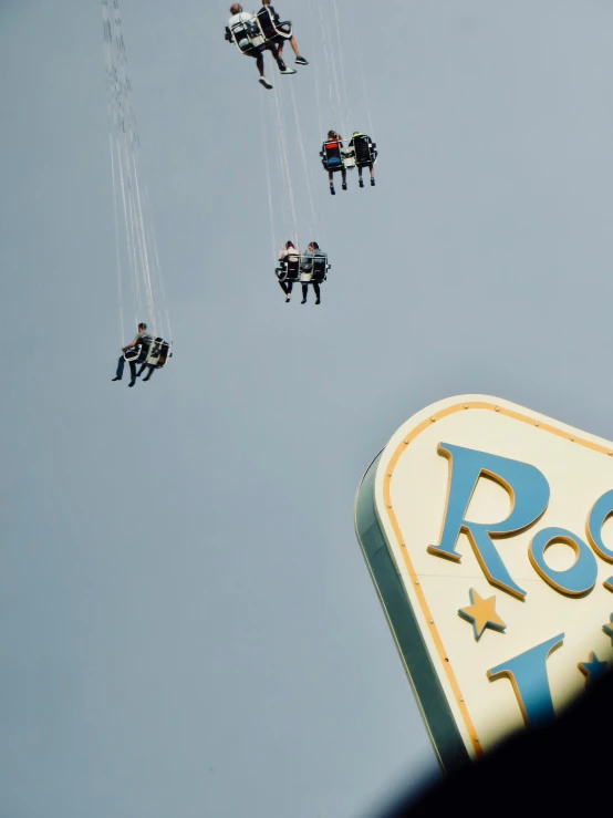 a group of people flying with some jets attached to them