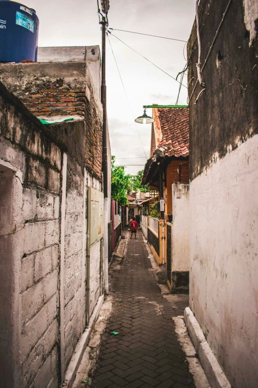 a narrow city street is seen in an old time pograph