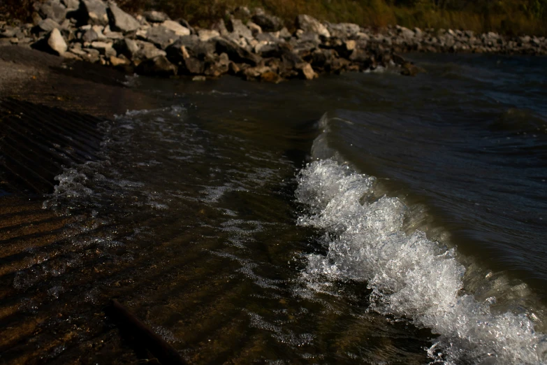 a wave crashing onto the beach on the shore