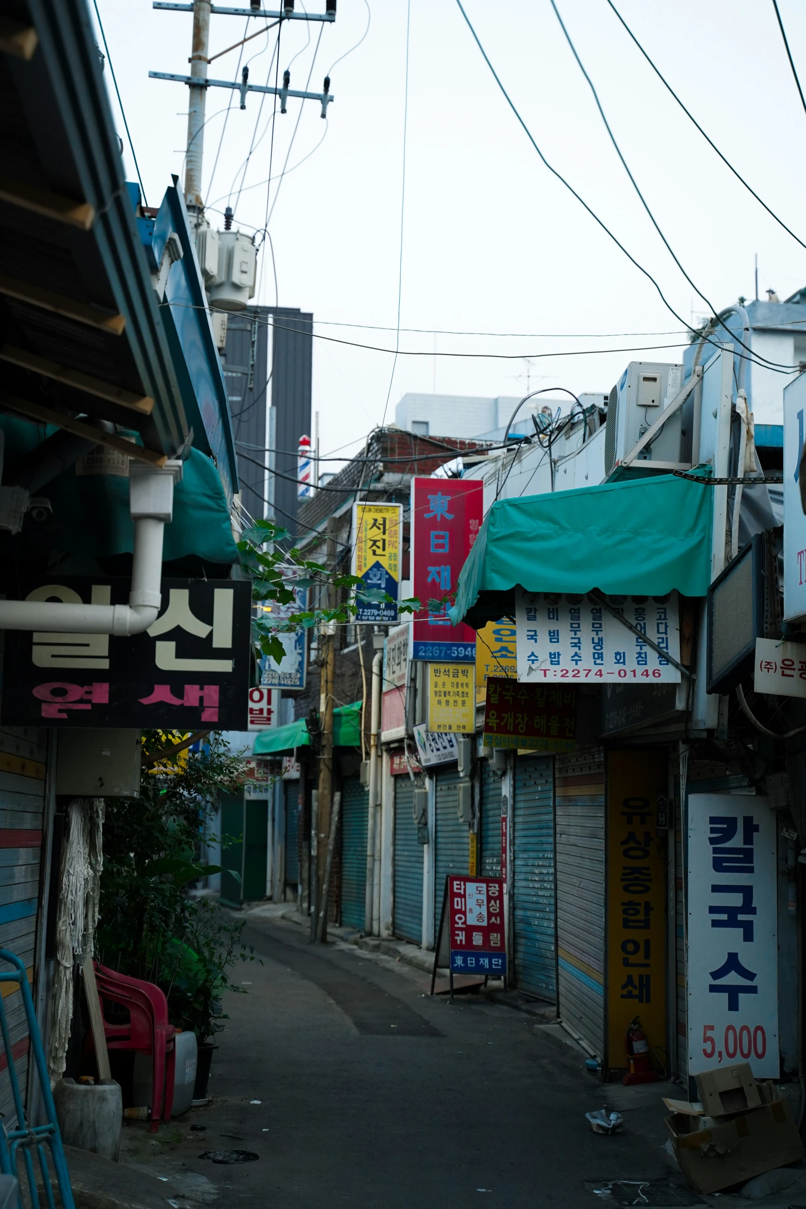 narrow alley with signposts and small shops