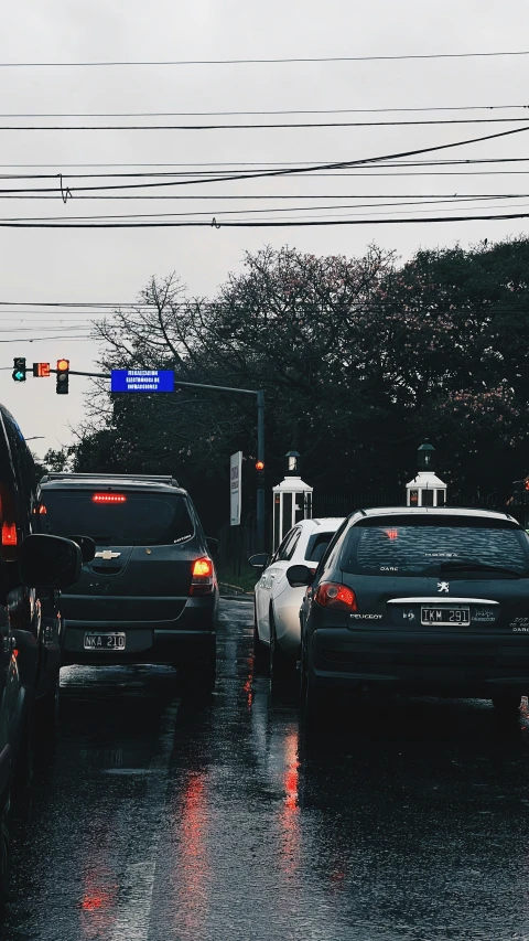 a car at a stoplight and another car at the red light