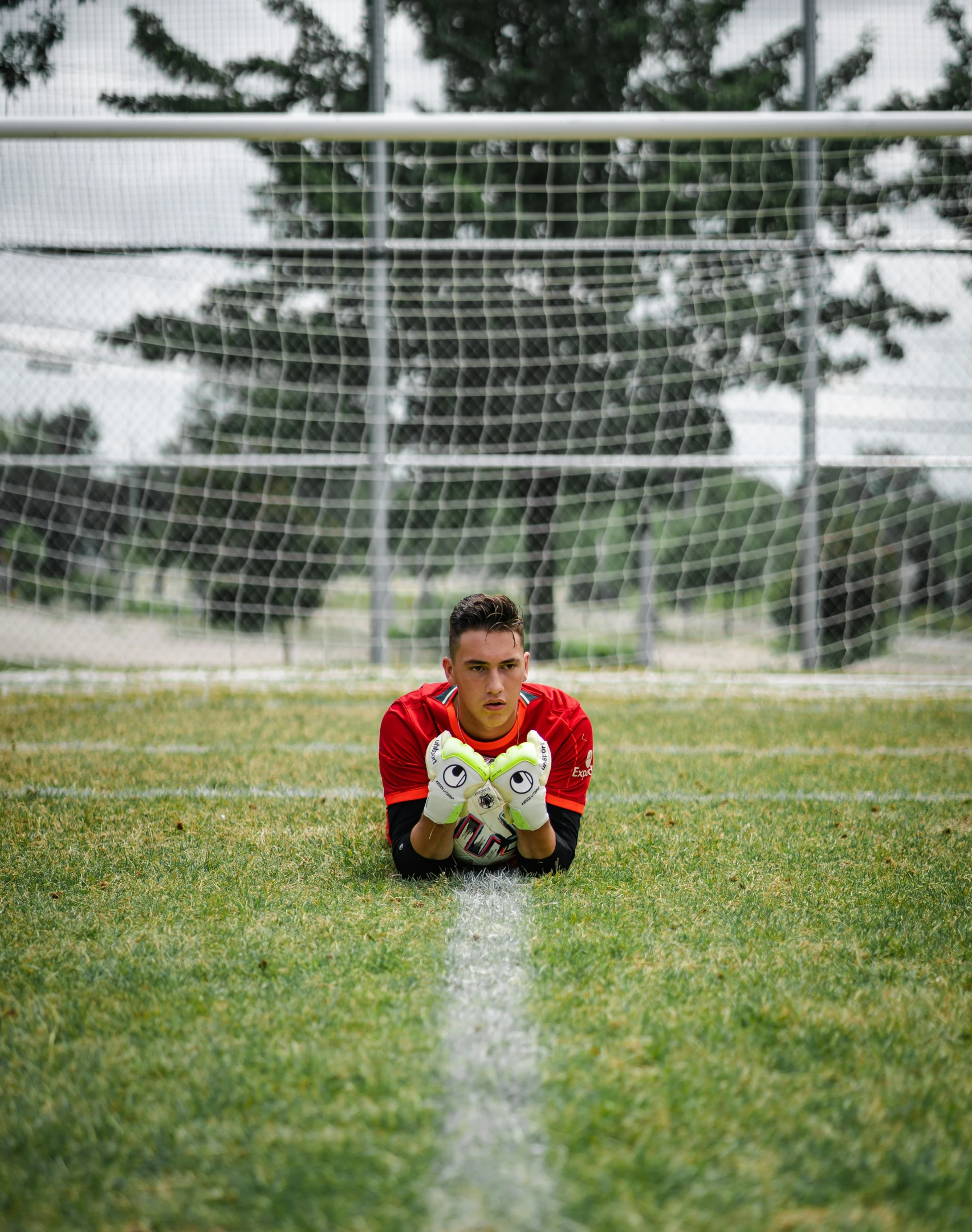 the man is kneeling on the soccer field