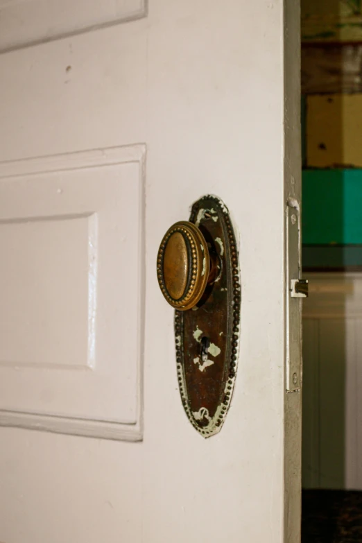 an open door with a gold handle and door 