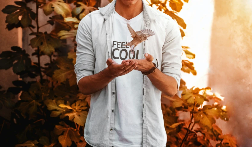 a man in a white shirt with his hands out