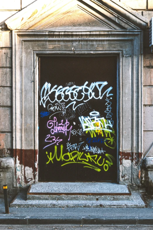 an open door with many graffiti written on it