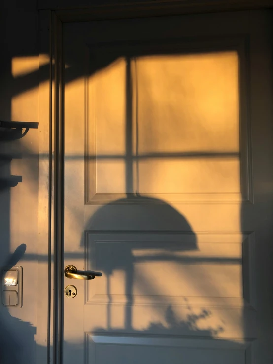 the shadow of a door and a chair on the wall