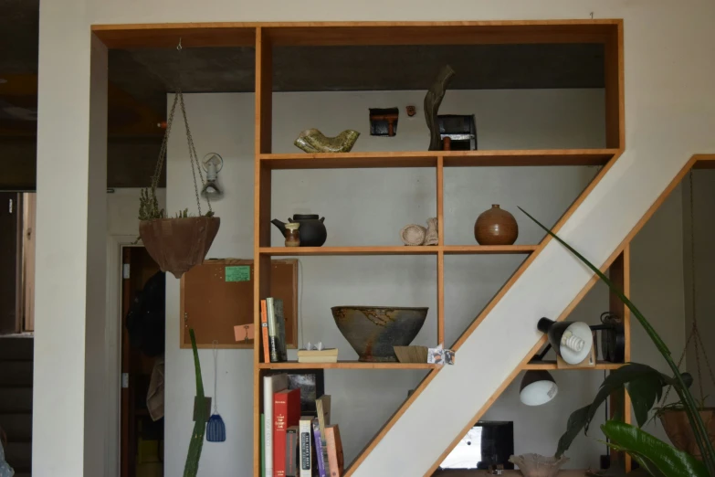 the stairs are in front of bookshelves in this home