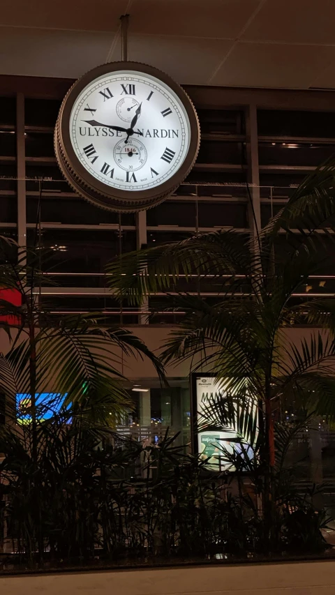 there is a large clock on the ceiling of the building