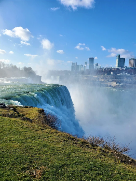 a beautiful view of the niagara falls and canadian city in the distance