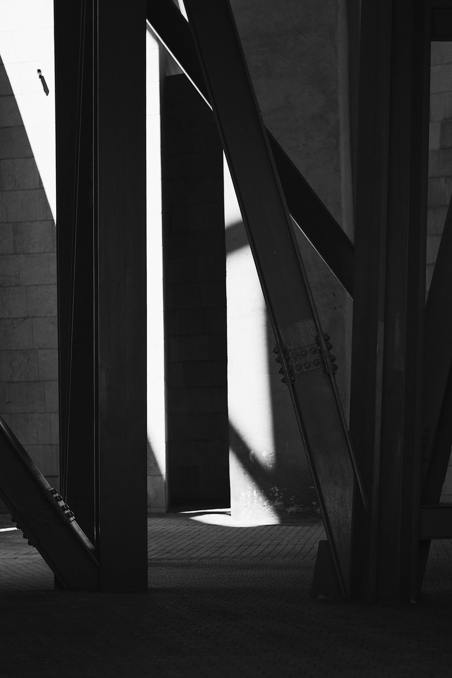 an outdoor po taken in black and white, of a cat on a railing