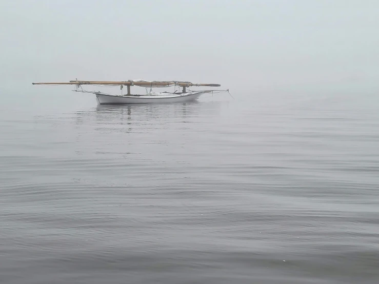 a boat sitting in the middle of a body of water