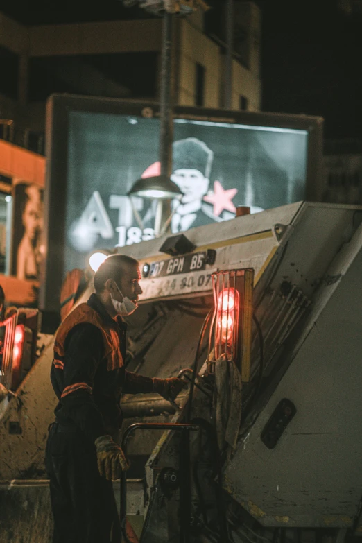 a man with safety gear sitting on top of a truck