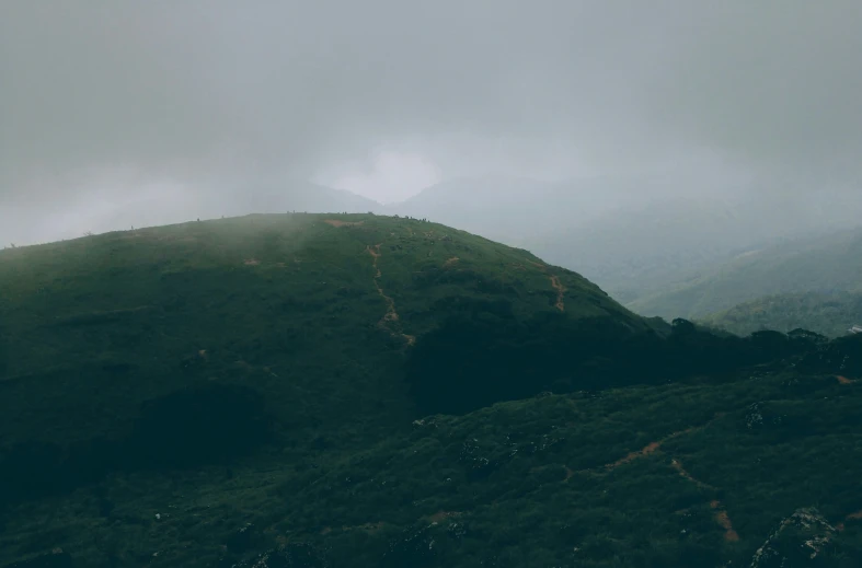 there are two mountains covered in dark hills