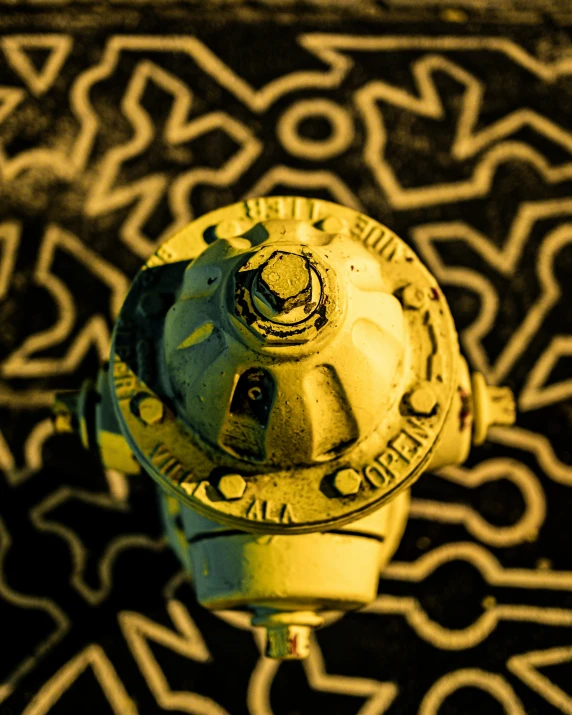 the view of a yellow fire hydrant on a tiled surface