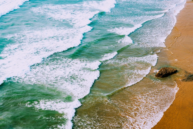 two rocks at the shore of an ocean