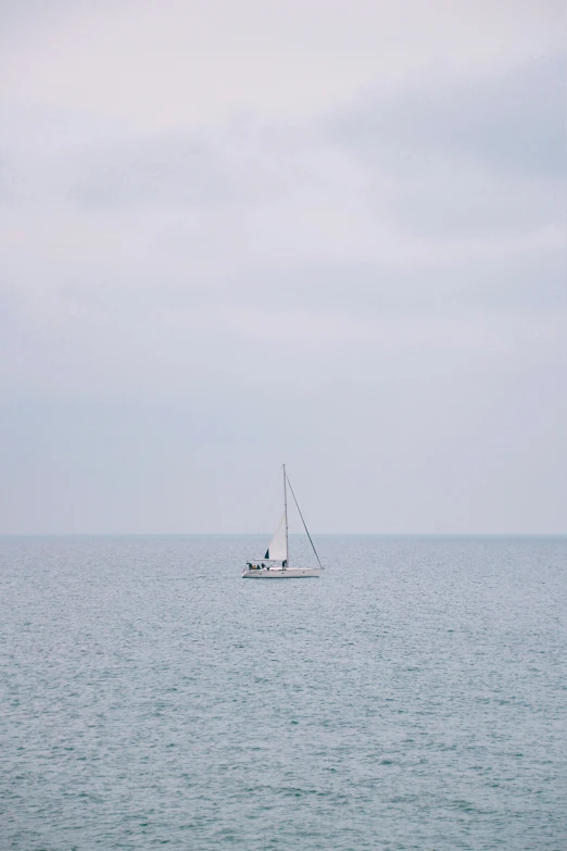 two boats in the ocean, one being pulled by a boat