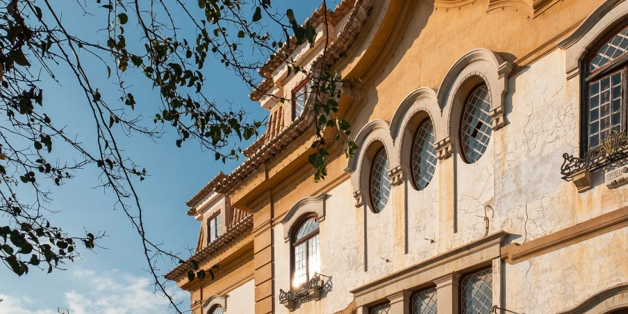 a building with windows and arched balconies on the side