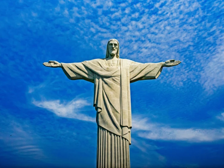 the christ statue is surrounded by blue skies