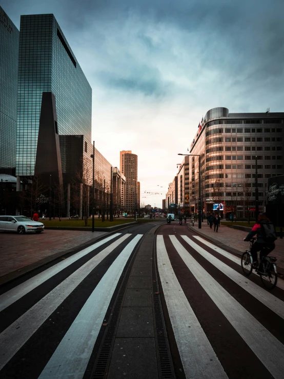 people riding bikes on a bike path in a big city