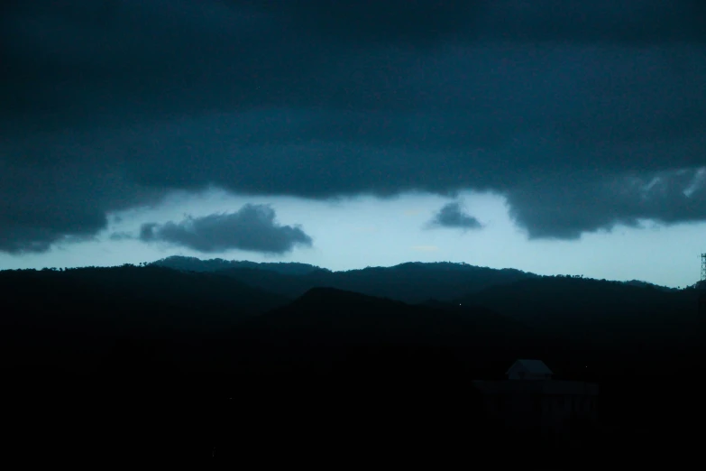 there are clouds and mountains in the distance