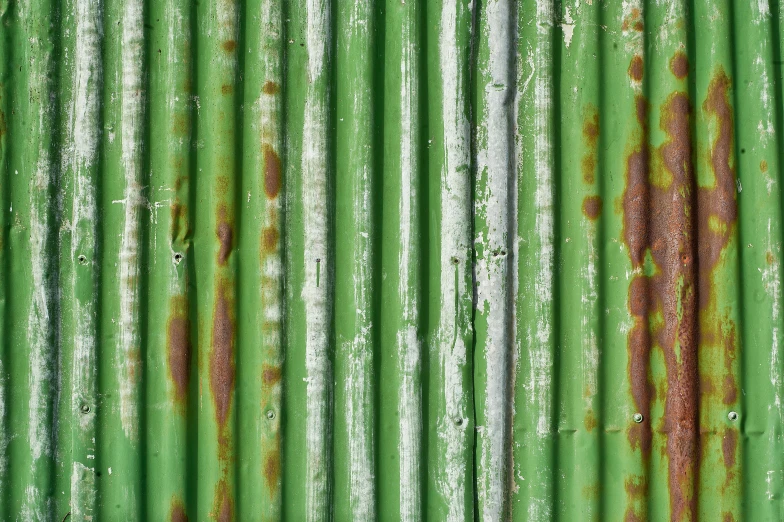 green painted corrugated sheets with rust on them