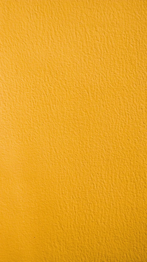 an orange colored texture wallpaper with little specks