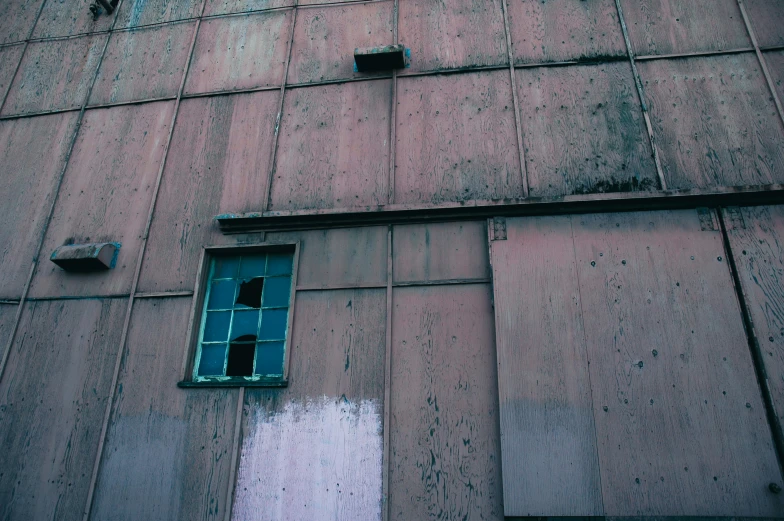 a dilapidated wall with the bottom window open