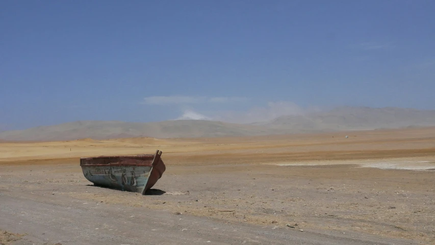 an empty, barren road stretches off to the distant mountain range