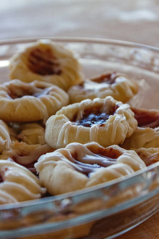 several snacks in a clear bowl with chocolate spread on top