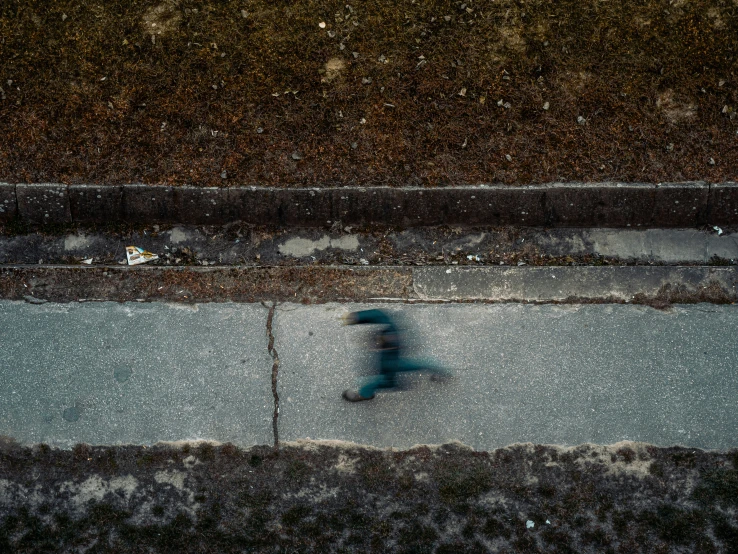 a person walking down the street holding an umbrella