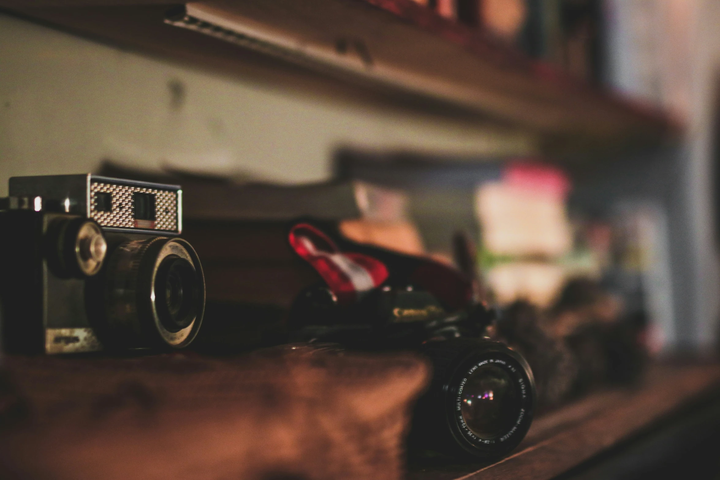 an old fashioned camera is sitting on top of some books