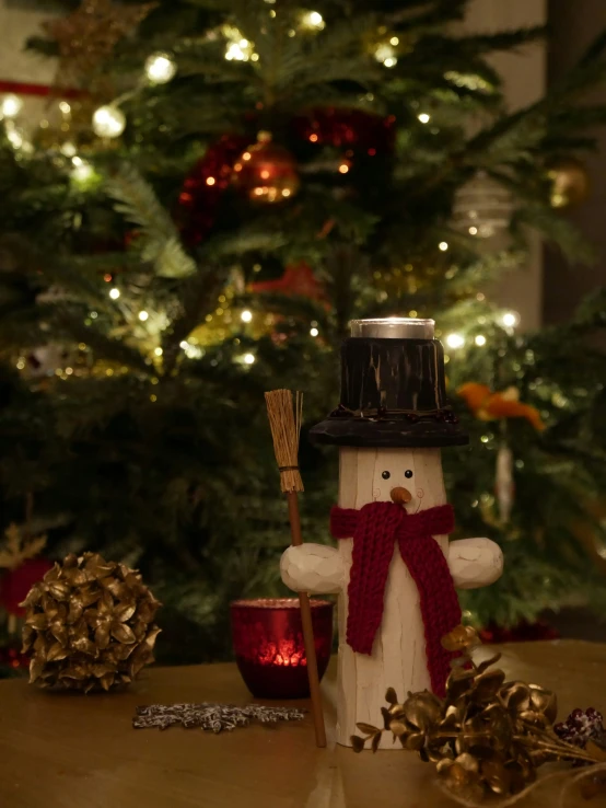 a snowman decoration next to a christmas tree