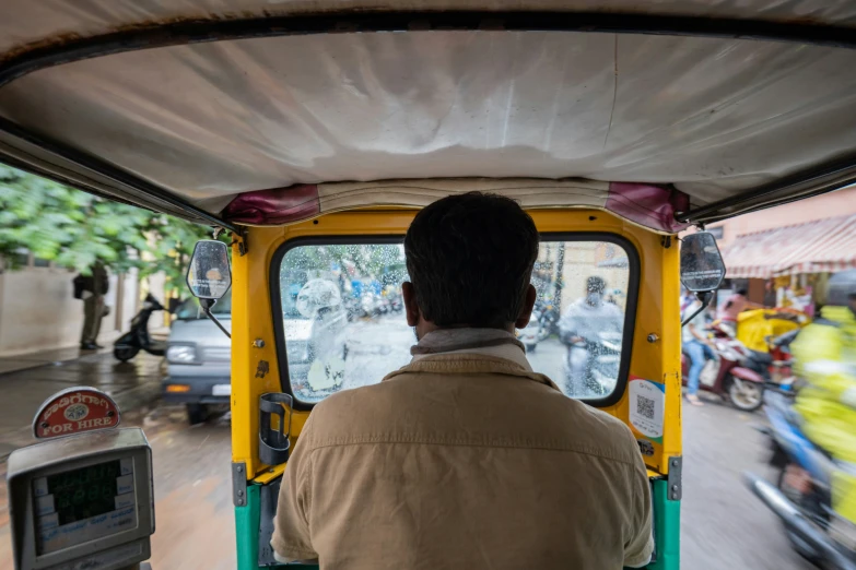 a person riding on a motor bike next to a machine