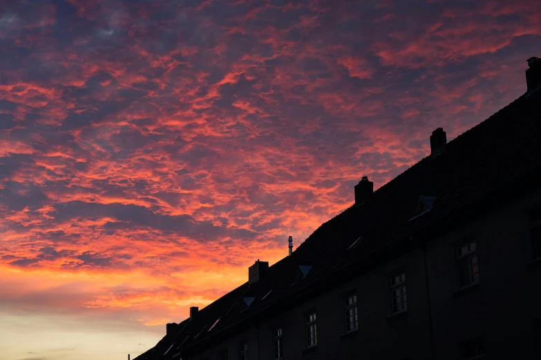 a building under red skies and clouds