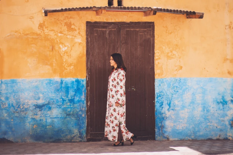 a woman standing in front of a doorway