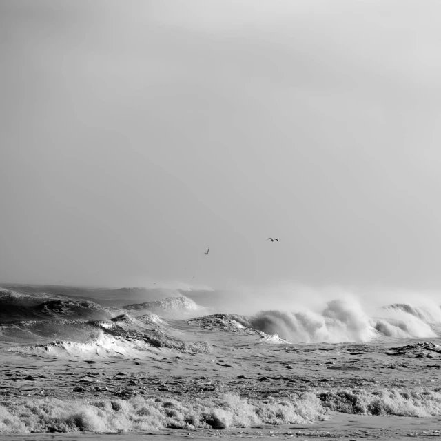 the ocean with waves crashing against the shore