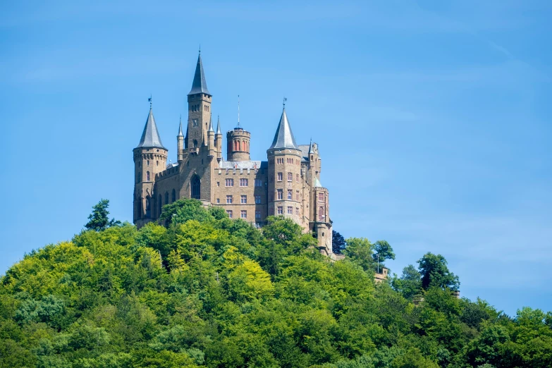 a very tall castle is on top of a hill