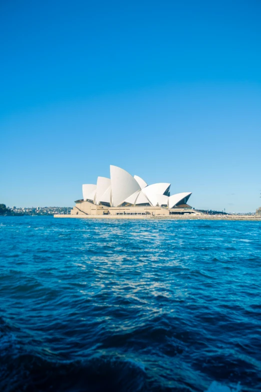 the sydney opera house on a calm blue sky