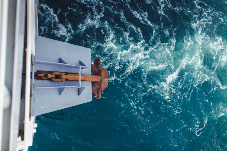 a view from above of a small boat approaching the sea