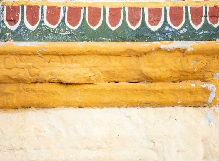 an orange and green wall with flowers growing on it