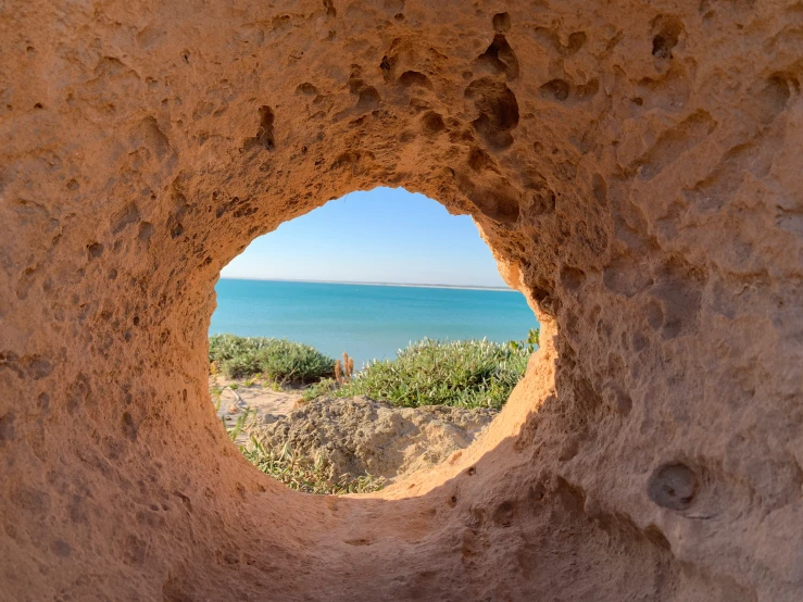 a view of an ocean from the window of a rock